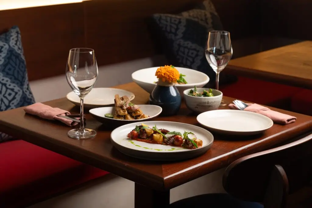 Category B — Restaurant / interior / atmosphere photos Elegant table setting with Balinese dishes at HOME by Chef Wayan, ...